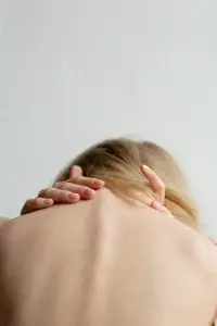 woman covering her breast with her hand